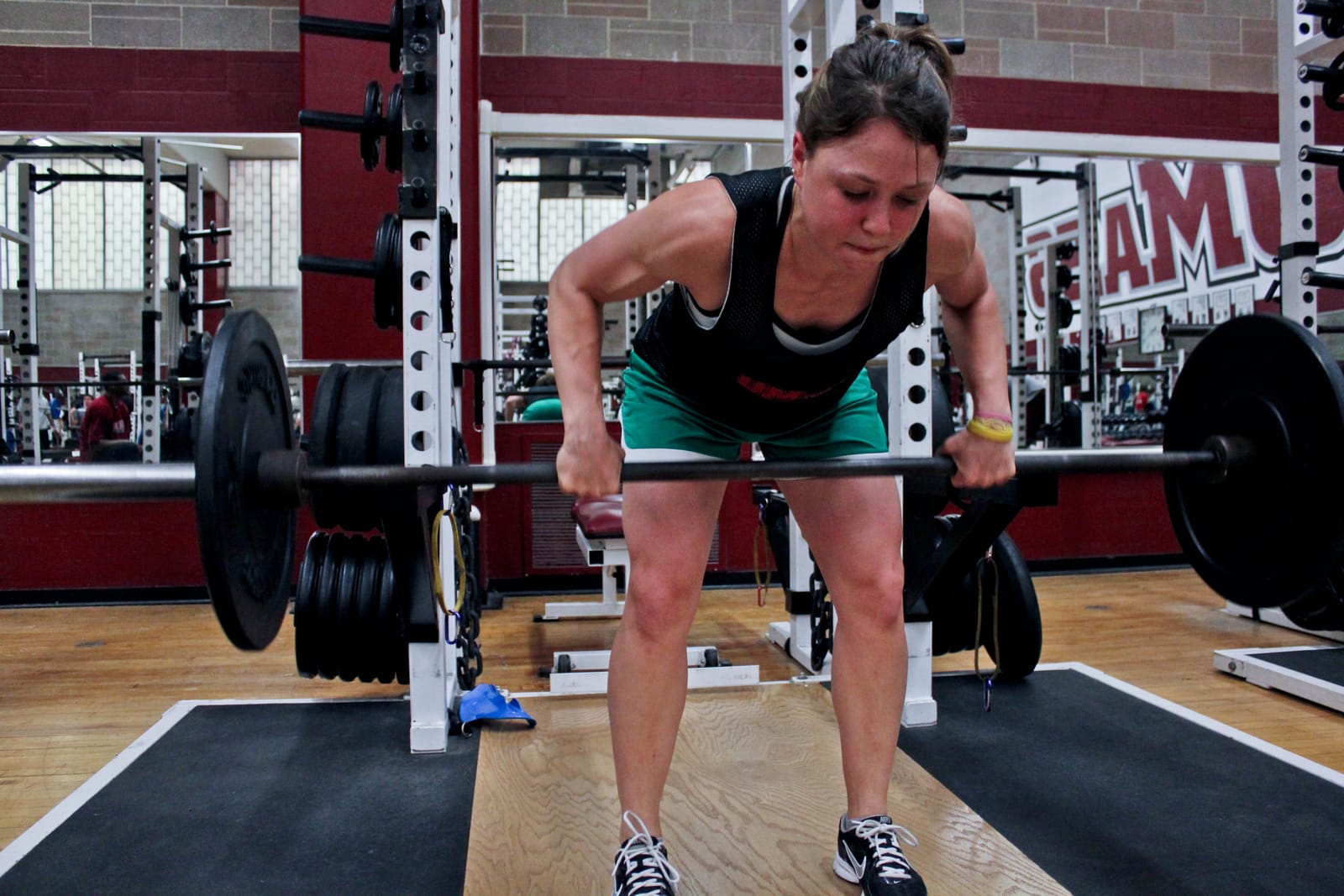 Pronated barbell bent-over row at peak contraction.