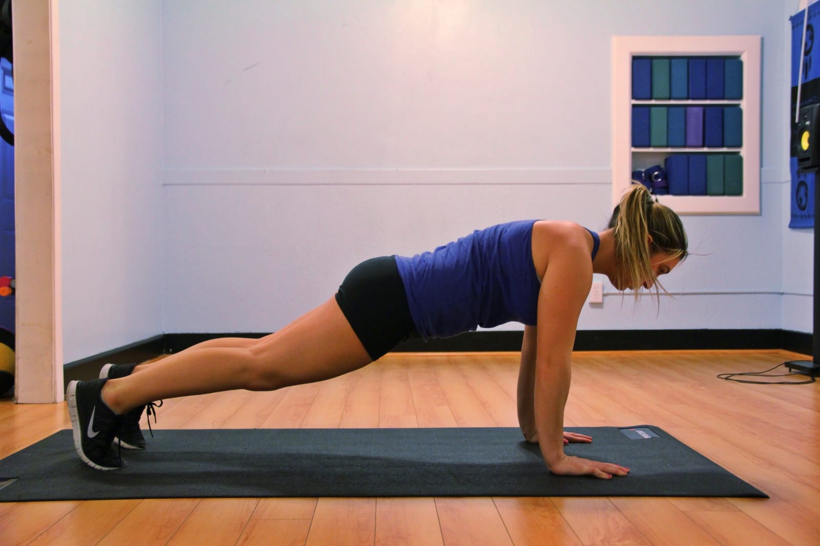 Side view of a high plank, body in one line.